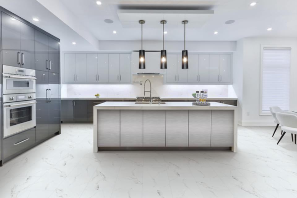 luxury vinyl tile flooring in kitchen with white counter and grey cabinets